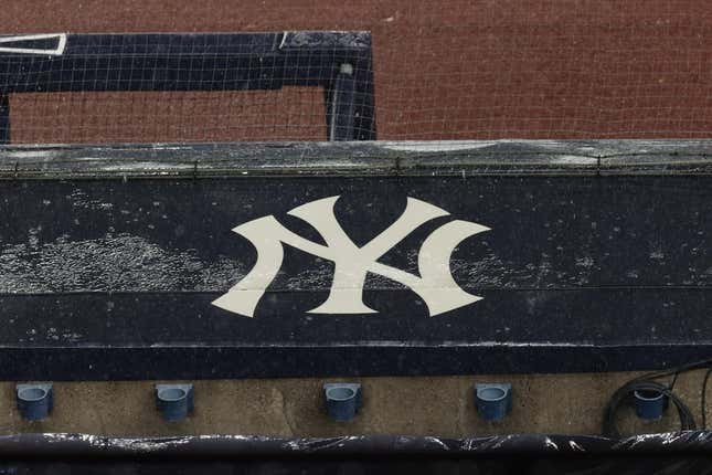 Aug 17, 2020; Bronx, New York, USA; A general view of rain falling on the New York Yankees logo on the first base dugout roof during a rain delay in the game between the New York Yankees and the Boston Red Sox.