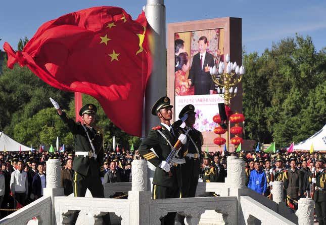 A paramilitary policeman unfurls a Chinese national flag at the celebrations event on Sept. 8.