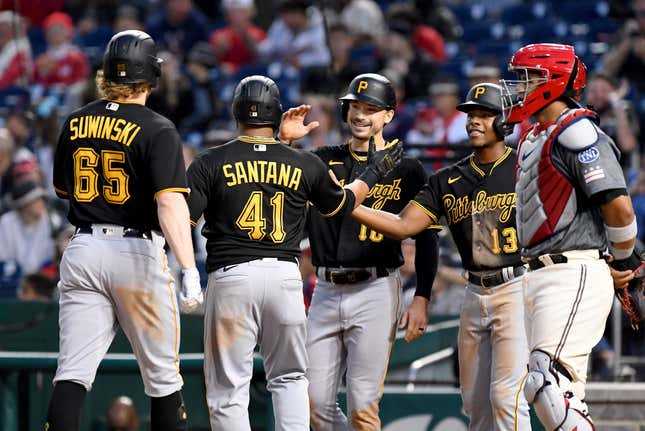 Bryan Reynolds, Carlos Santana (41), and Ke’Bryan Hayes celebrate Jack Suwinski’s grand slam against Washington on April 29.