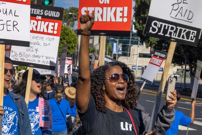 LOS ANGELES, CA - MAY 02: People picket outside of Paramount Pictures on the first day of the Hollywood writers strike on May 2, 2023 in Los Angeles. Scripted TV series, late-night talk shows, film and streaming productions are being interrupted by the Writers Guild of America (WGA) strike