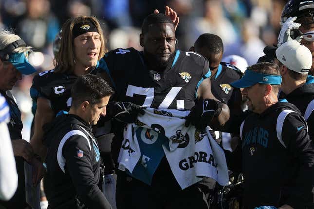 Jacksonville Jaguars offensive lineman Cam Robinson (74) tears up after an apparent injury as quarterback Trevor Lawrence (16) pats him on the head during the fourth quarter of a regular season NFL football matchup Sunday, Dec. 18, 2022 at TIAA Bank Field in Jacksonville. The Jacksonville Jaguars edged the Dallas Cowboys 40-34 in overtime. [Corey Perrine/Florida Times-Union]

Jki 121822 Cowboys Jags Cp 46