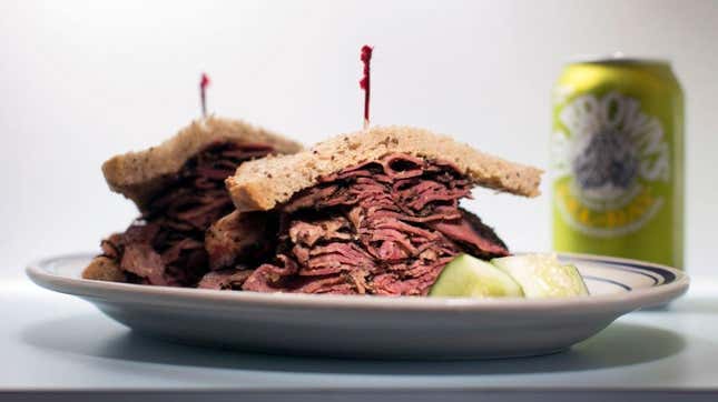 A pastrami sandwich on rye with pickle and Dr. Brown's Cel-Ray soda