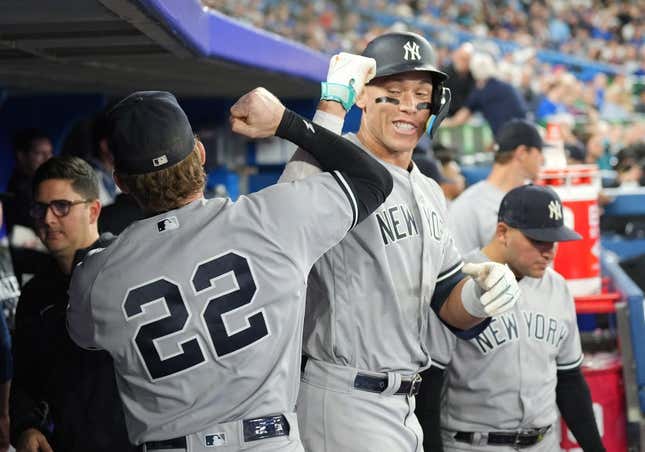 May 15, 2023; Toronto, Ontario, CAN; New York Yankees right fielder Aaron Judge (99) celebrates in the dugout with center fielder Harrison Bader (22) after hitting a home run against the Toronto Blue Jays during the eighth inning at Rogers Centre.
