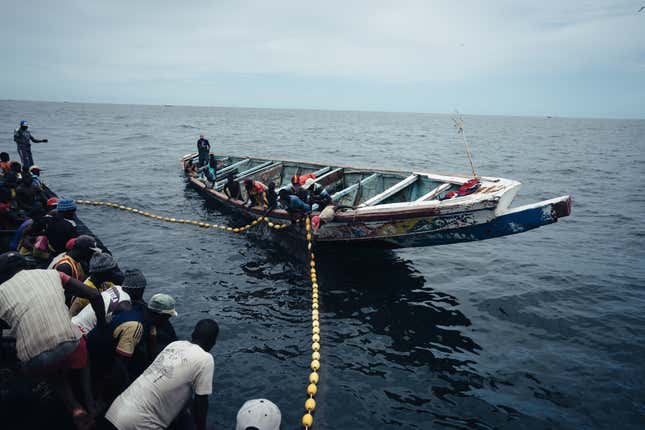 Local fishermen beat the sides of their boat and sing traditional songs as they pull their nets in.