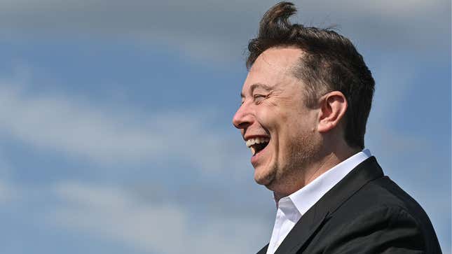 A photo of Elon Musk laughing. 