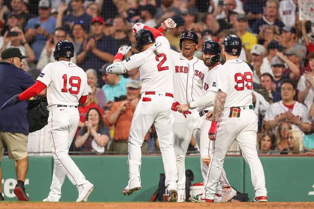 Jun 16, 2023; Boston, Massachusetts, USA; Boston Red Sox designated hitter Justin Turner (2) celebrates with teammates after hitting a grand slam during the third inning against the New York Yankees at Fenway Park.