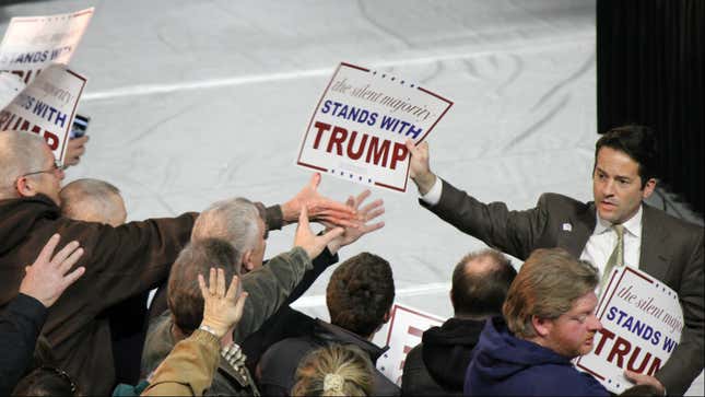 A Trump campaign staffer hands out posters in Muscatine, Iowa.