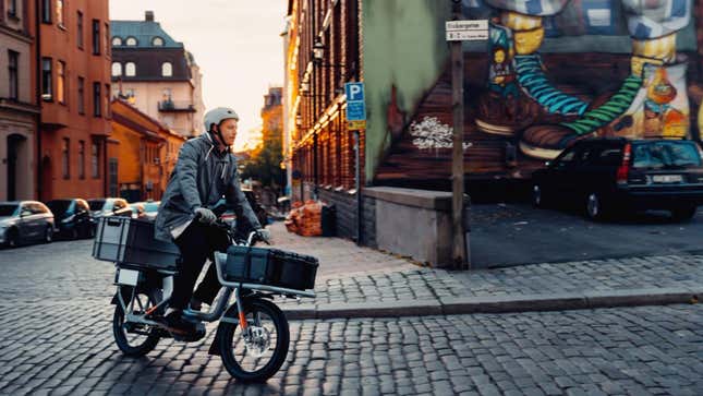 A photo of someone riding a Cake e-bike on the street.