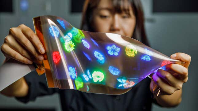 A person demonstrating the flexibility of LG's new 12-inch high-res OLED panel.