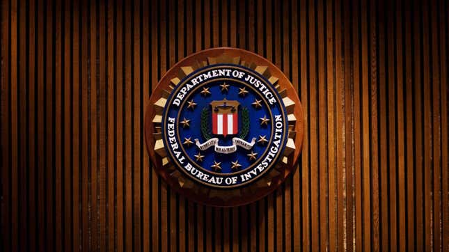 An image of a plaque that reads "Federal Bureau of Investigation" is shown against a wooden paneled background.