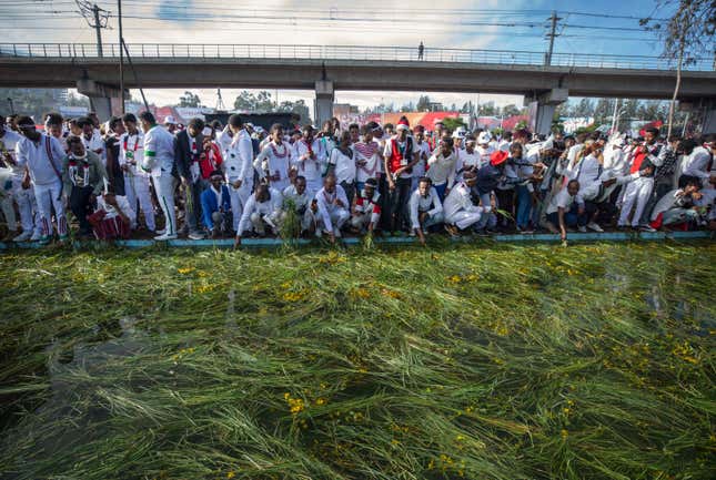 Ethiopians throw grass into a pool of water, as a symbol of riches after the rainy season and to thank the land and water for everything they have provided, as they celebrate the annual Irrecha thanksgiving festival in the capital Addis Ababa, Ethiopia Saturday, Oct. 5, 2019. The annual Irrecha festival of Ethiopia's largest ethnic group, the Oromo, attracted millions from across Ethiopia and was held in the capital for the first time after 150 years on Saturday.