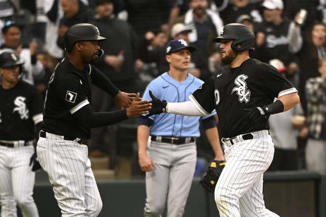 Apr 29, 2023; Chicago, Illinois, USA;  Chicago White Sox designated hitter Eloy Jimenez (74), left, and Chicago White Sox third baseman Jake Burger (30) high five after scoring against the Tampa Bay Rays during the second inning at Guaranteed Rate Field.