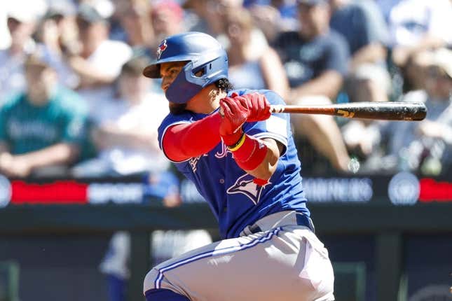 Jul 23, 2023; Seattle, Washington, USA; Toronto Blue Jays second baseman Santiago Espinal (5) hits an RBI-single against the Seattle Mariners during the seventh inning at T-Mobile Park.