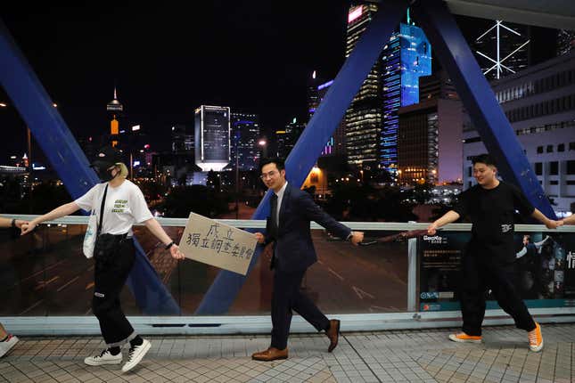 Demonstrators link hands as they gather along an elevated walkway in Hong Kong.