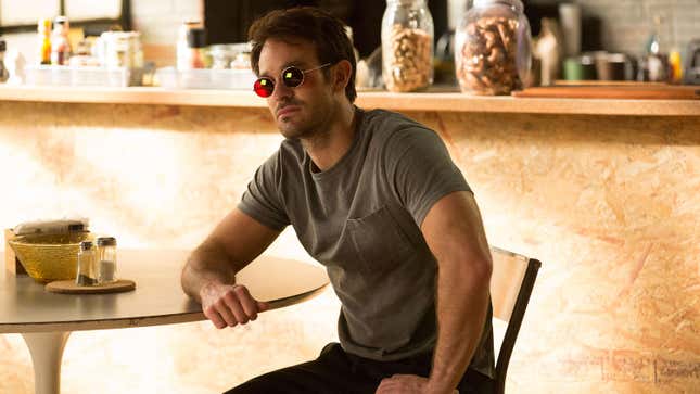 Daredevil/Matt Murdock sitting at a table.