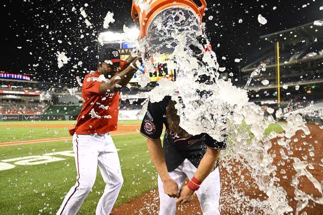 Sep 6, 2023; Washington, District of Columbia, USA; Washington Nationals outfielder Jacob Young (30) is doused with water by Washington Nationals outfielder Victor Robles (16) after hitting a walk off RBI single against the New York Mets during the ninth inning at Nationals Park.