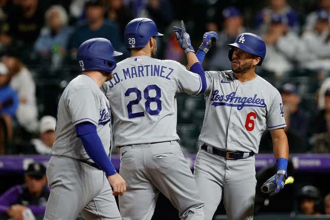Jun 29, 2023; Denver, Colorado, USA; Los Angeles Dodgers designated hitter J.D. Martinez (28) celebrates his two run home run with left fielder David Peralta (6) and third baseman Max Muncy (13) in the fourth inning against the Colorado Rockies at Coors Field.