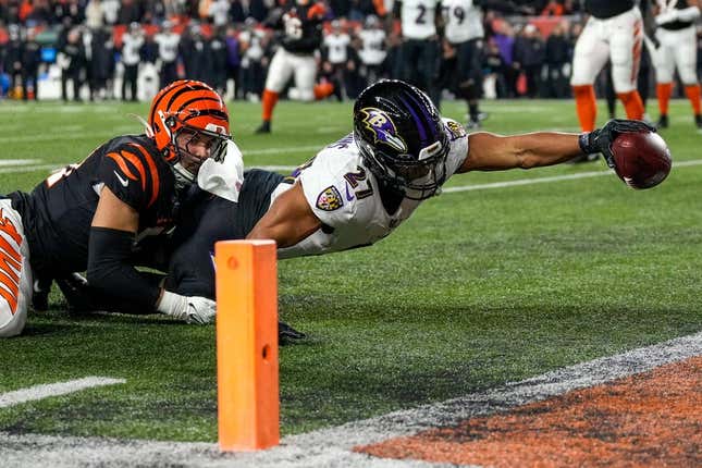 Baltimore Ravens running back J.K. Dobbins (27) breaks a tackle from Cincinnati Bengals linebacker Markus Bailey (51) stretches to break the plane for a touchdown in the second quarter during an NFL wild-card playoff football game between the Baltimore Ravens and the Cincinnati Bengals, Sunday, Jan. 15, 2023, at Paycor Stadium in Cincinnati.The Ravens led 10-9 at halftime.

Baltimore Ravens At Cincinnati Bengals Afc Wild Card Jan 15 124