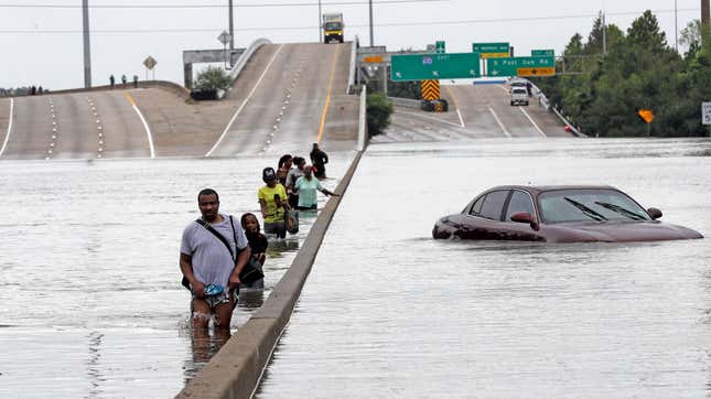 Evacuees wade through floodwaters after Hurricane Harvey in August of 2017. 