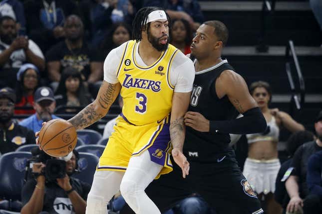 Feb 28, 2023; Memphis, Tennessee, USA; Los Angeles Lakers forward Anthony Davis (3) handles the ball as Memphis Grizzlies forward Xavier Tillman (2) defends during the first half at FedExForum.
