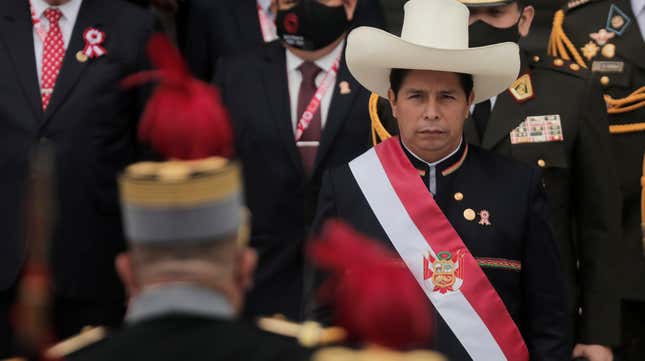 Peruvian president Pedro Castillo wears a hat and sash