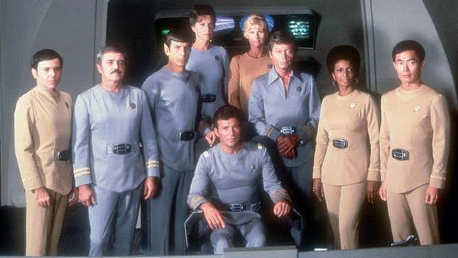 The crew of the classic Enterprise pose in their uniforms in 1979's Star Trek: The Motion Picture.
