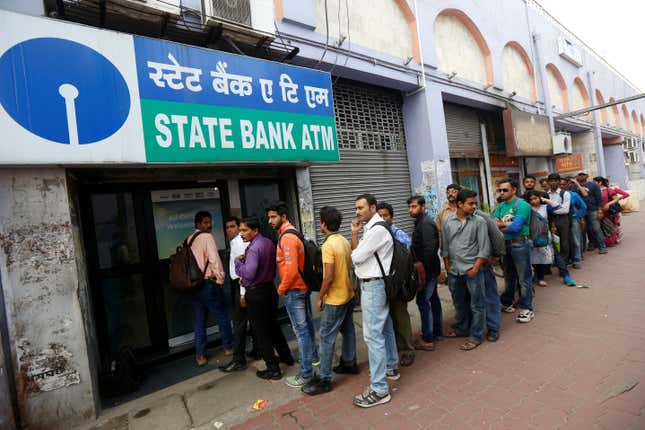 People queue outside an ATM of State Bank of India.