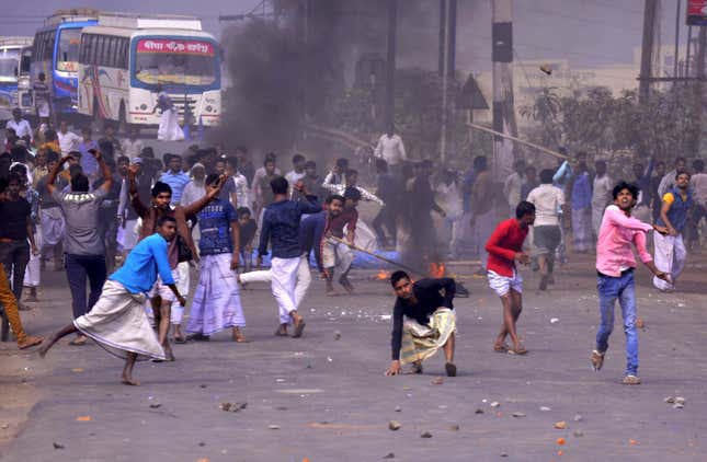 Protesters throw stones at the police at Santragachi in Howrah district of West Bengal on Dec.14.