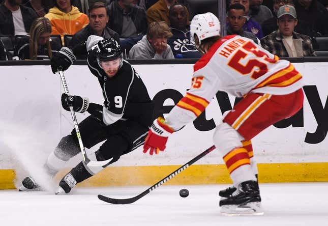 Mar 20, 2023; Los Angeles, California, USA; Los Angeles Kings right wing Adrian Kempe (9) moves the puck during second period against Calgary Flames defenseman Noah Hanifin (55) at Crypto.com Arena.