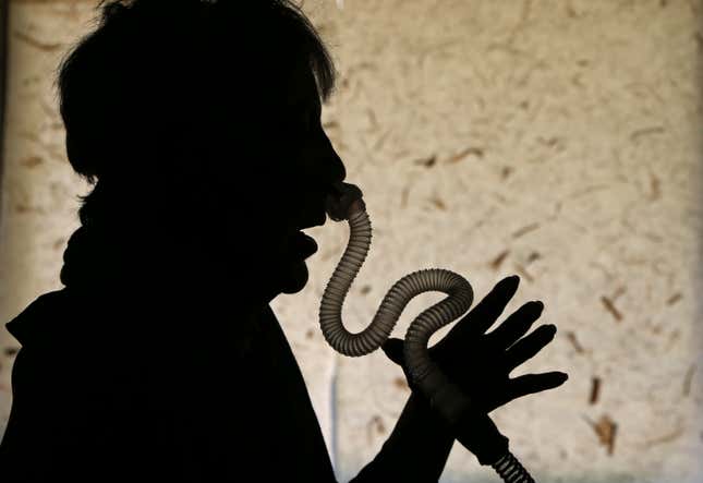 Woman wearing sleep apnea breathing device