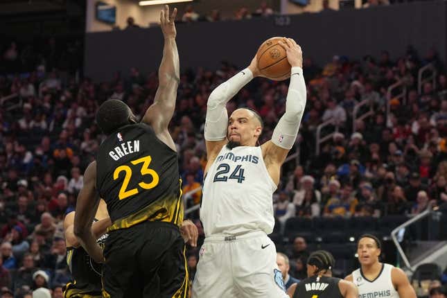 Dec 25, 2022; San Francisco, California, USA; Memphis Grizzlies forward Dillon Brooks (24) handles the ball against Golden State Warriors forward Draymond Green (23) during the fourth quarter at Chase Center.