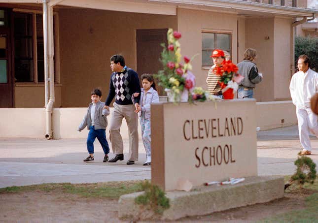A man and two students arrive back at Cleveland Elementary School in Stockton, Calif., Jan. 17, 1989 after a heavily armed gunman invaded the school yard and killed five children and injured 30 others before killing himself.