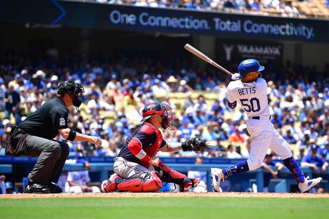 May 17, 2023; Los Angeles, California, USA; Los Angeles Dodgers right fielder Mookie Betts (50) hits an RBI single against the Minnesota Twins during the fourth inning at Dodger Stadium.