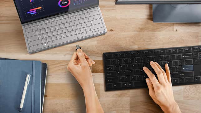 A conceptual image showing the Compal Electronics Mobile Office laptop taking up less room on a desk when it's folded.