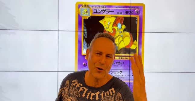 Geller stood in front of a large screen with a Kadabra card displayed.