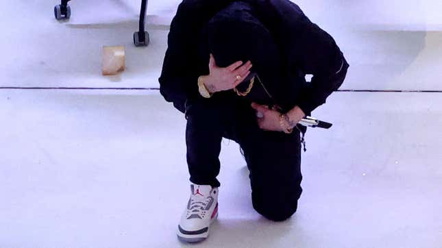 Eminem kneeling during his Super Bowl LVI halftime performance.