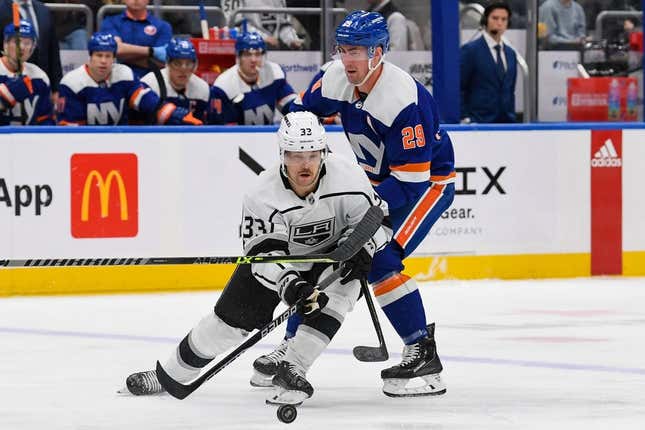 Feb 24, 2023; Elmont, New York, USA;  Los Angeles Kings right wing Viktor Arvidsson (33) skates with the puck defended by New York Islanders center Brock Nelson (29) during the first period at UBS Arena.
