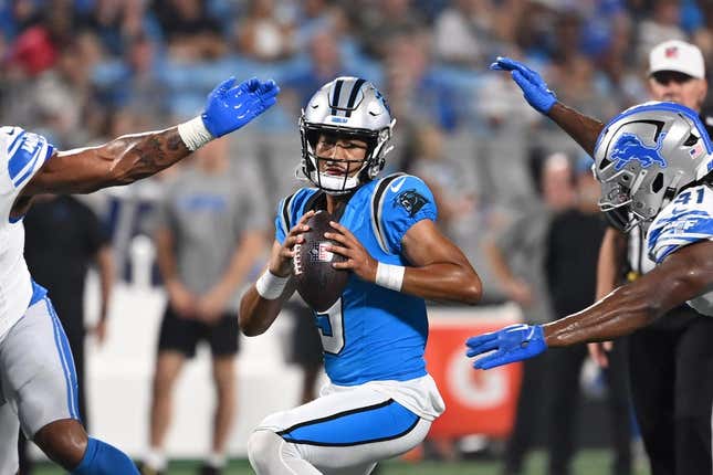 Aug 25, 2023; Charlotte, North Carolina, USA; Carolina Panthers quarterback Bryce Young (9) is sacked by Detroit Lions linebacker James Houston (41) as defensive end Romeo Okwara (95) helps defend in the first quarter at Bank of America Stadium.