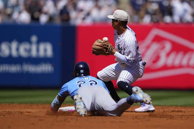 May 14, 2023; Bronx, New York, USA; Tampa Bay Rays center fielder Jose Siri (22) slides safely into second base with a double with New York Yankees second baseman Oswaldo Cabrera (95) receiving the throw during the third inning at Yankee Stadium.