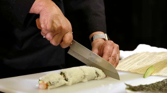 A sushi roll will get sliced by someone keeping a knife
