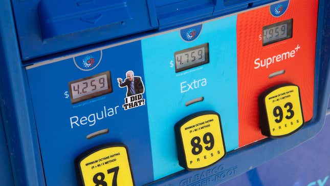 A gas pump displays current fuel prices, along with a sticker of US President Joe Biden, at a gas station in Arlington, Virginia, on March 16, 2022. (Photo by SAUL LOEB / AFP) 