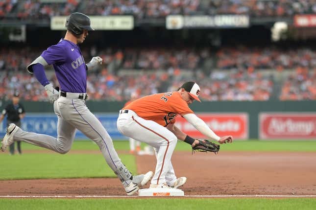 Aug 26, 2023; Baltimore, Maryland, USA;  Baltimore Orioles first baseman Ryan Mountcastle (6) secures the ball for the forecourt of Colorado Rockies right fielder Nolan Jones (22) during the second inning at Oriole Park at Camden Yards.