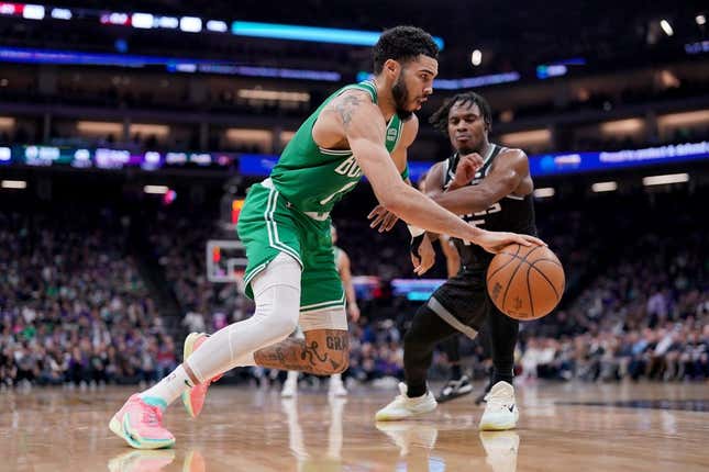 Mar 21, 2023; Sacramento, California, USA; Boston Celtics forward Jayson Tatum (0) dribbles past Sacramento Kings guard Davion Mitchell (15) in the second quarter at the Golden 1 Center.
