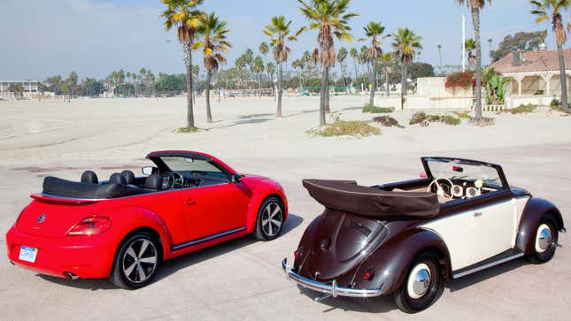 A photo of two VW Beetle cars parked on a beach. 