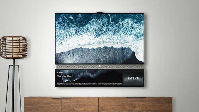 A Telly TV on teh wall displaying a photo of the ocean alongside a bottom bar with an ad for Kia.