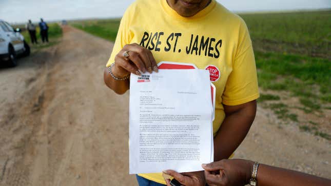 Sharon Lavigne, a member of RISE St. James, holds a letter addressed to the St. James Parish Sheriff, explaining their legal right to access to a burial site on Formosa property in St. James Parish, Louisiana, Wednesday, March 11, 2020. Archaeologists have found that the land bought for a planned $9.4 billion plastics complex may include up to seven slave cemeteries rather than two previously described, local activists said Wednesday. 