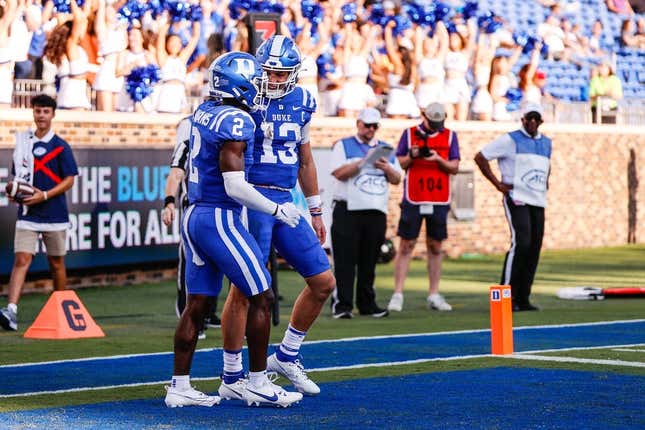 Sep 16, 2023; Durham, North Carolina, USA; Duke Blue Devils quarterback Riley Leonard (13) scores a touchdown and celebrates with wide receiver Sahmir Hagans (2) during the second half against Northwestern Wildcats at Wallace Wade Stadium.