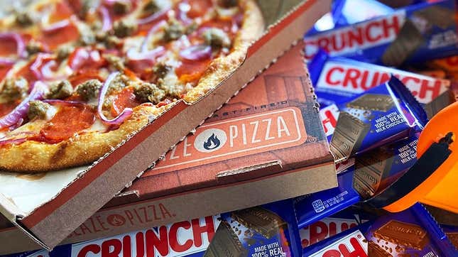 Open box of Blaze Pizza on top of a pile of Crunch bars