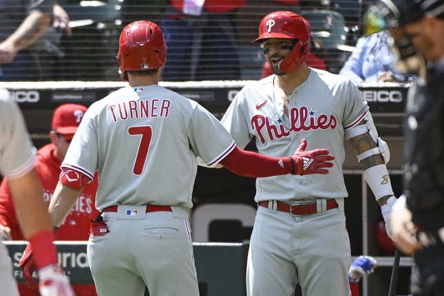 Apr 19, 2023; Chicago, Illinois, USA;  Philadelphia Phillies shortstop Trea Turner (7)  high fives Philadelphia Phillies right fielder Nick Castellanos (8), right, after he hits a home run against the Chicago White Sox during the first inning at Guaranteed Rate Field.