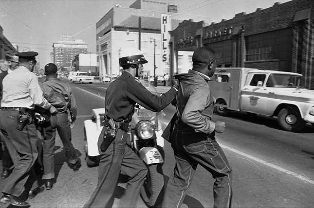 Rev. Martin Luther King, Jr., left, and Rev. Ralph Abernathy, right, are arrested by police during the demonstration in Birmingham.